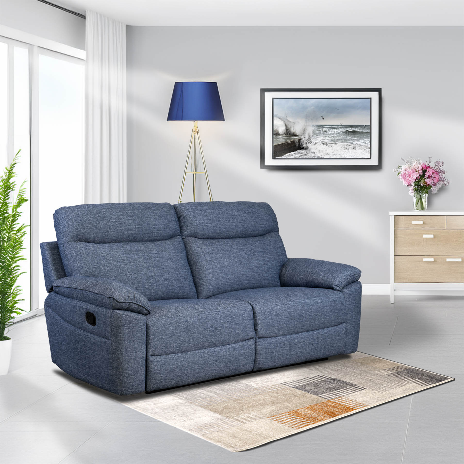 Blue sofa in a living room with a lamp, painting, and cabinet.