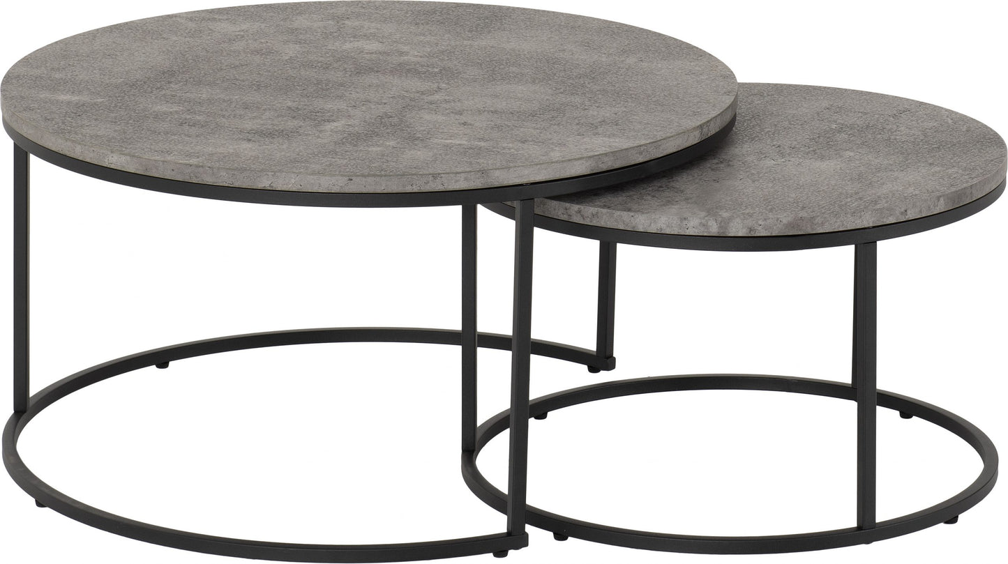Set of two round coffee tables with gray tops and black metal bases on a white background