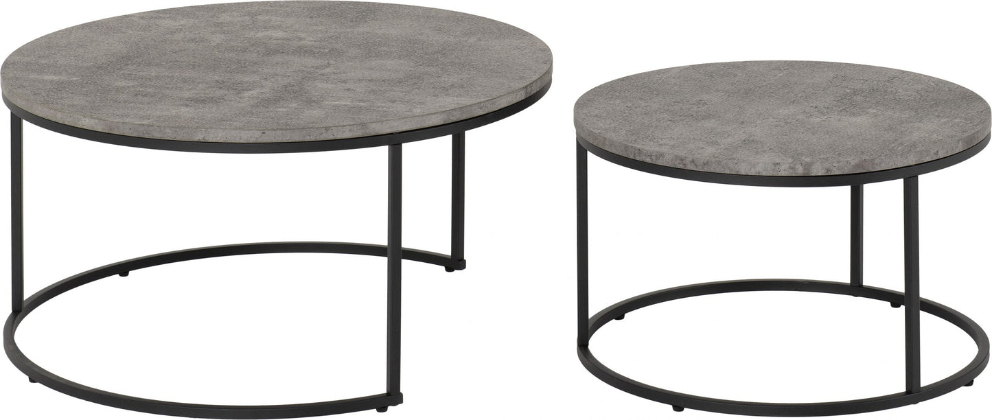 Two round concrete coffee tables with black metal bases on a white background