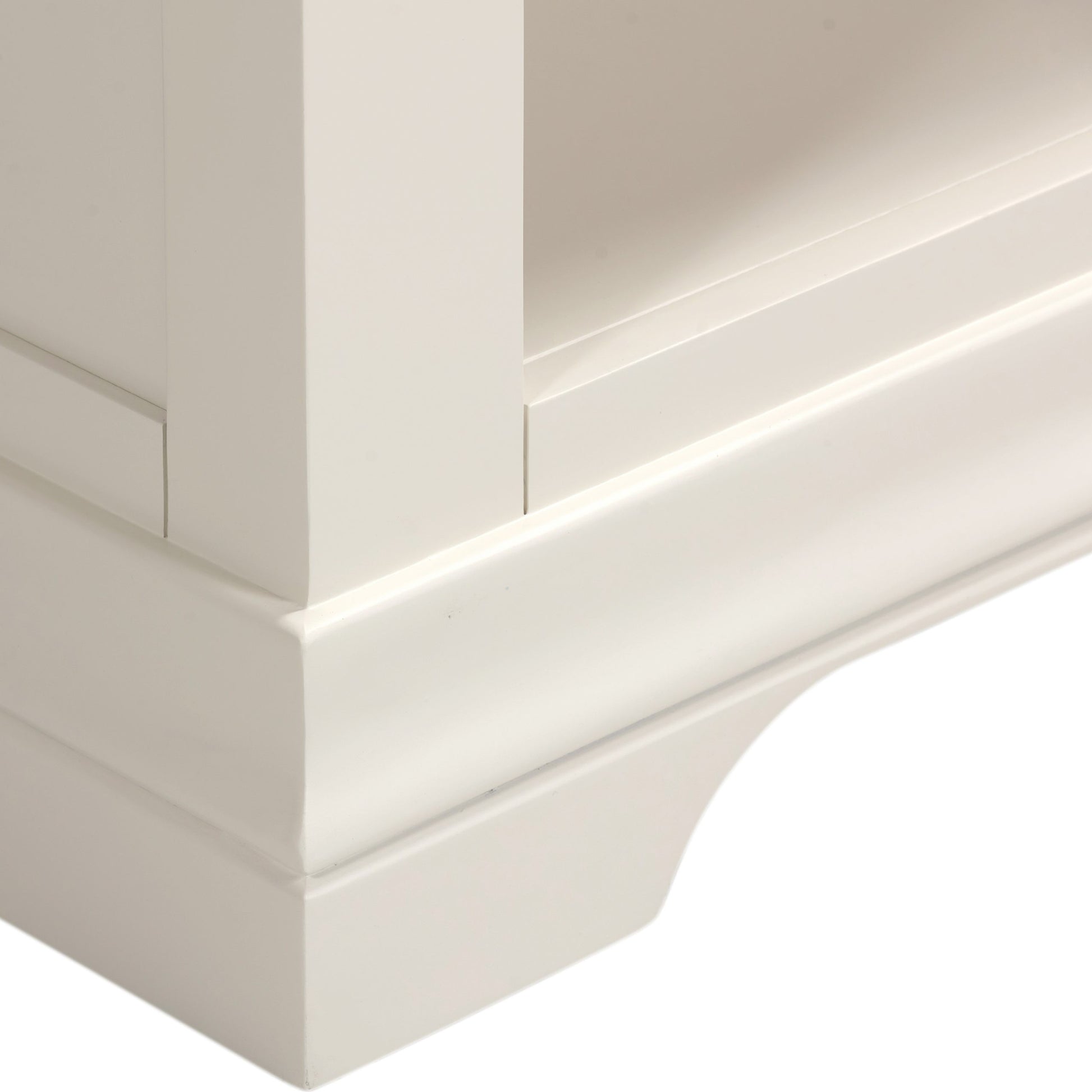 Close-up of a white wooden cabinet corner with a smooth finish.