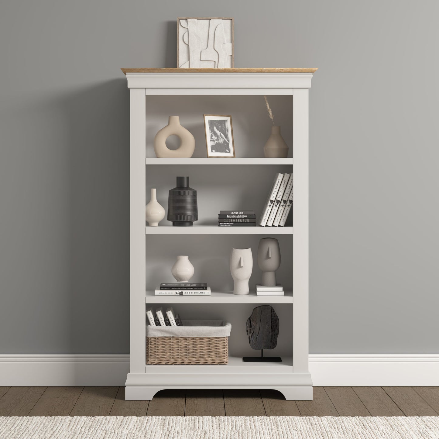 White bookshelf with decorative items against a gray wall