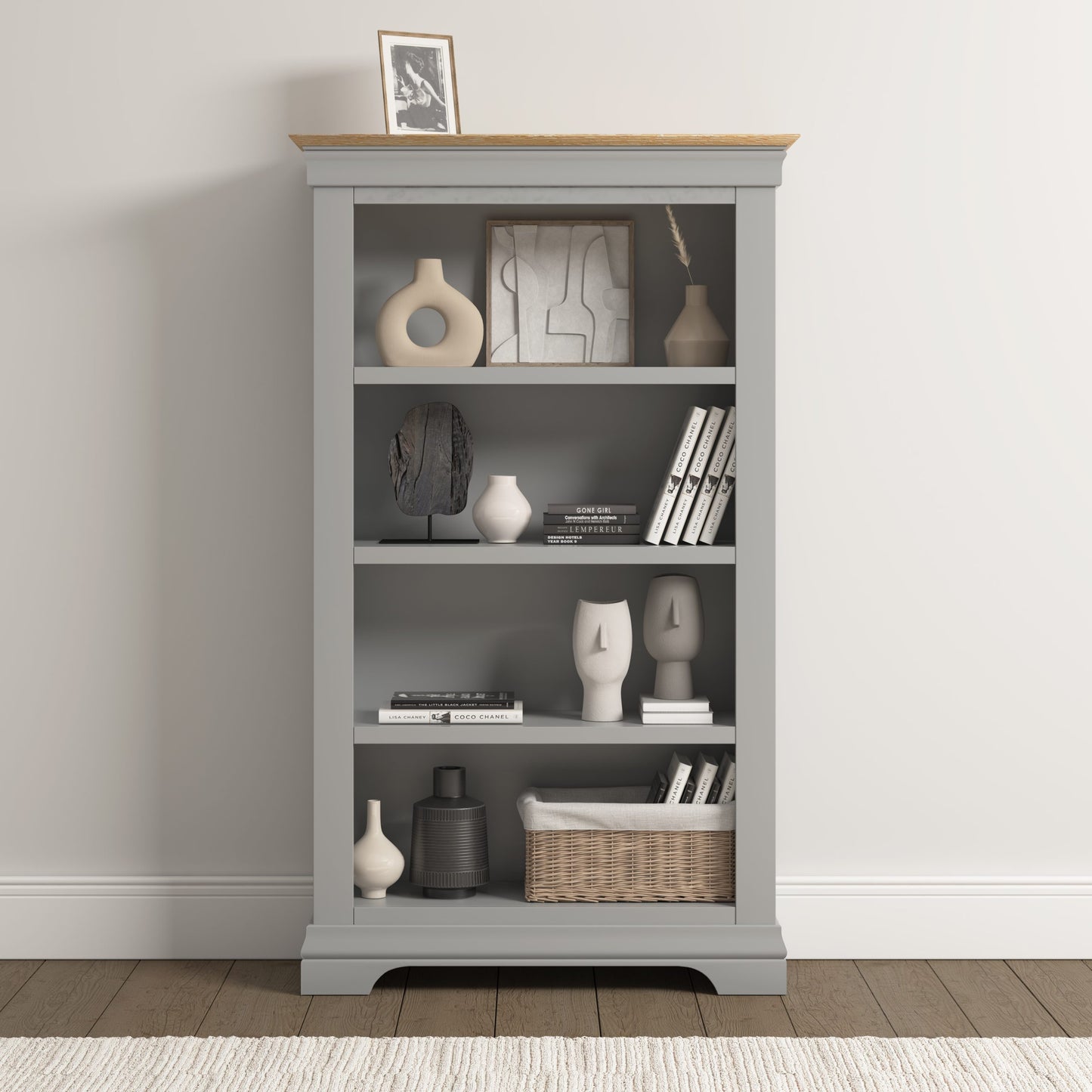 Gray bookshelf with decorative items against a plain wall