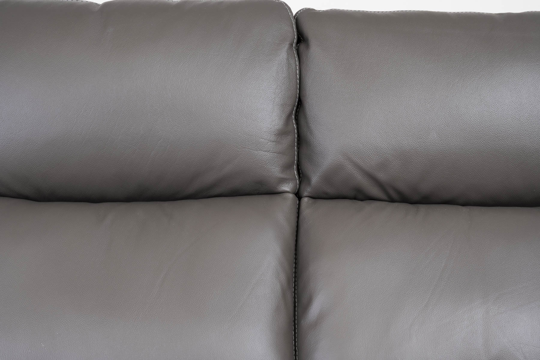 Gray leather sofa with a plain background