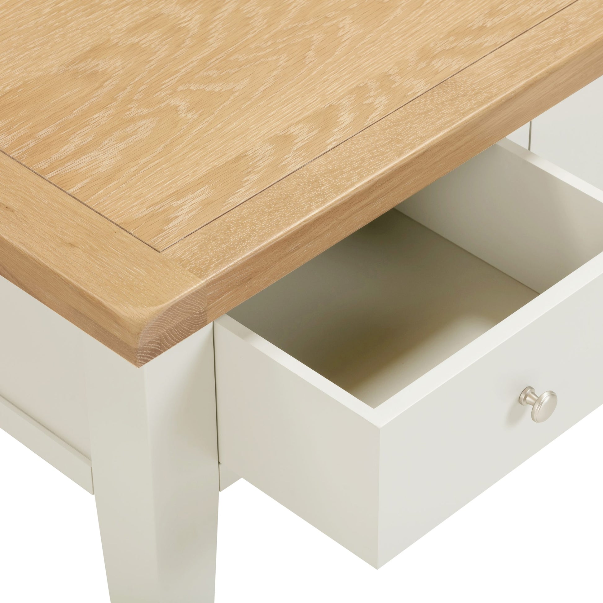 Wooden table with an open drawer, showing a light wood finish and white interior.