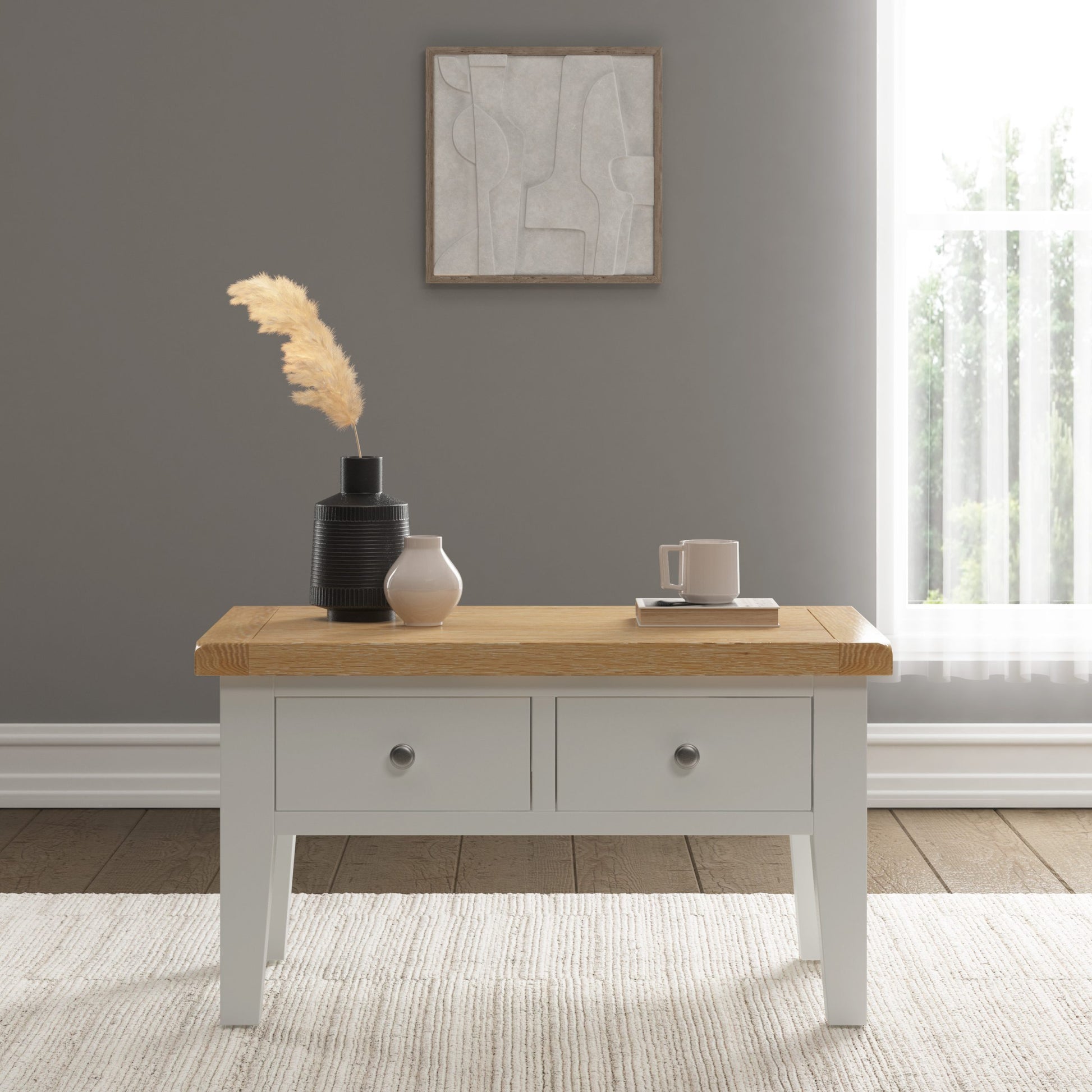 Wooden coffee table with decorative items in a room with a gray wall and a window.