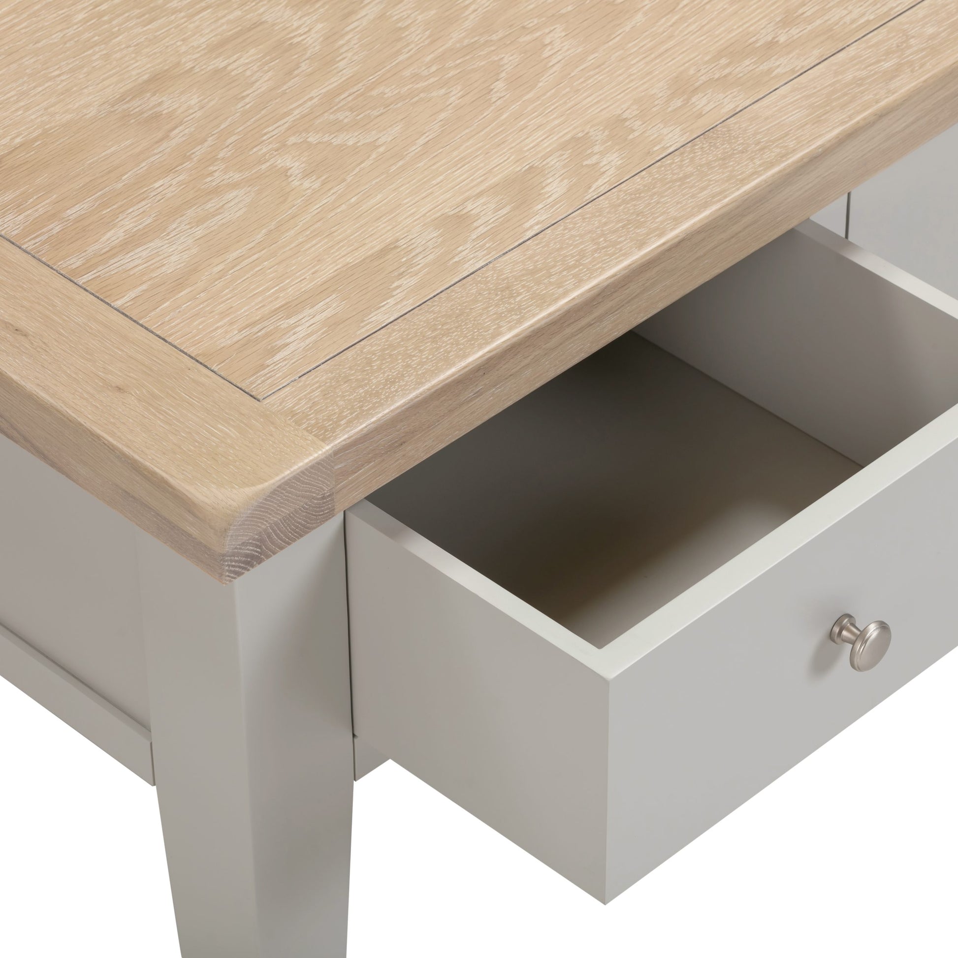 Wooden table with an open drawer in a neutral setting
