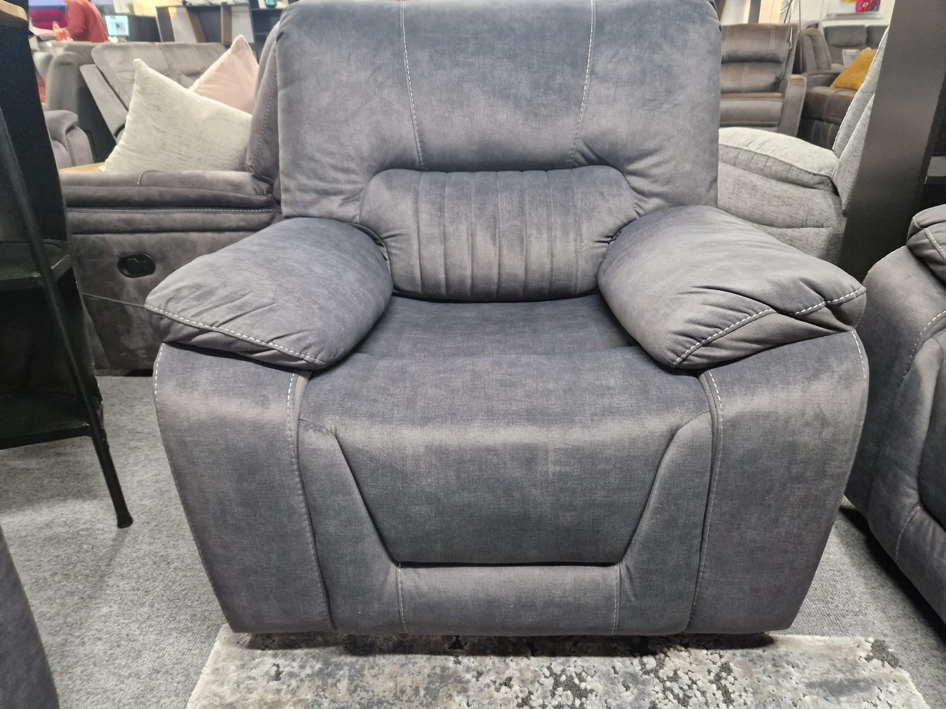 Gray recliner chair in a furniture store setting