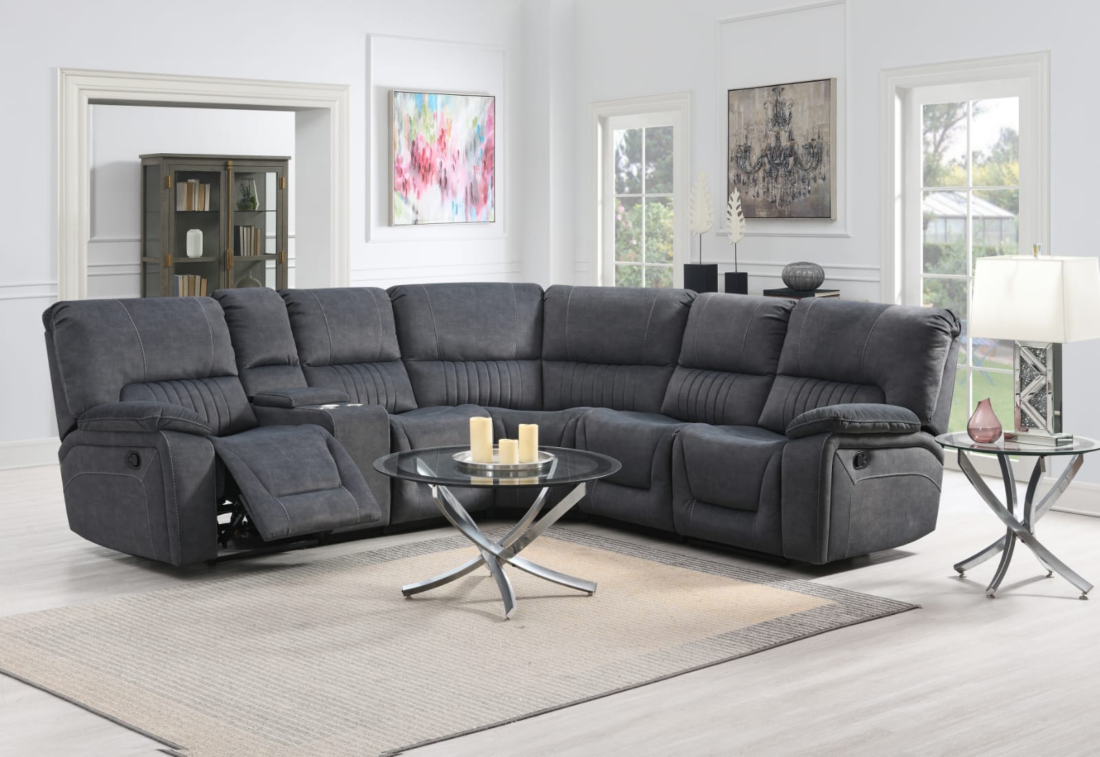 Dark Gray Fabric sectional reclining corner sofa in a living room with a glass coffee table and decorative items.