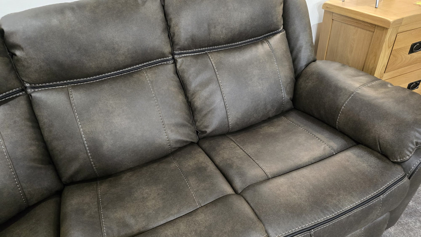 Gray leather sofa in a room with wooden furniture.