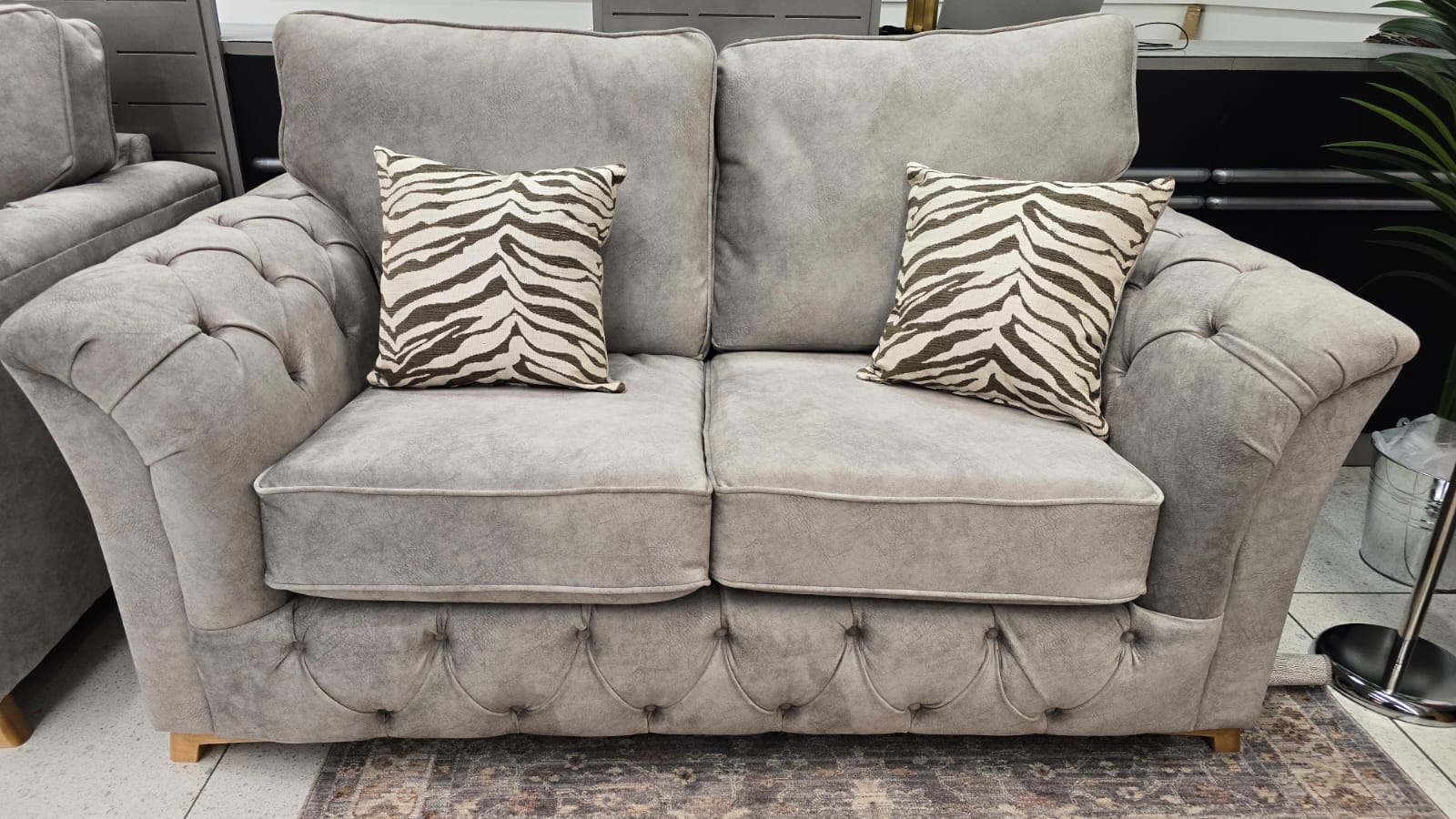 light grey sofa with zebra print cushions in a room setting