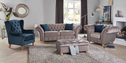 Living room with gray and blue furniture set on a light wood floor.