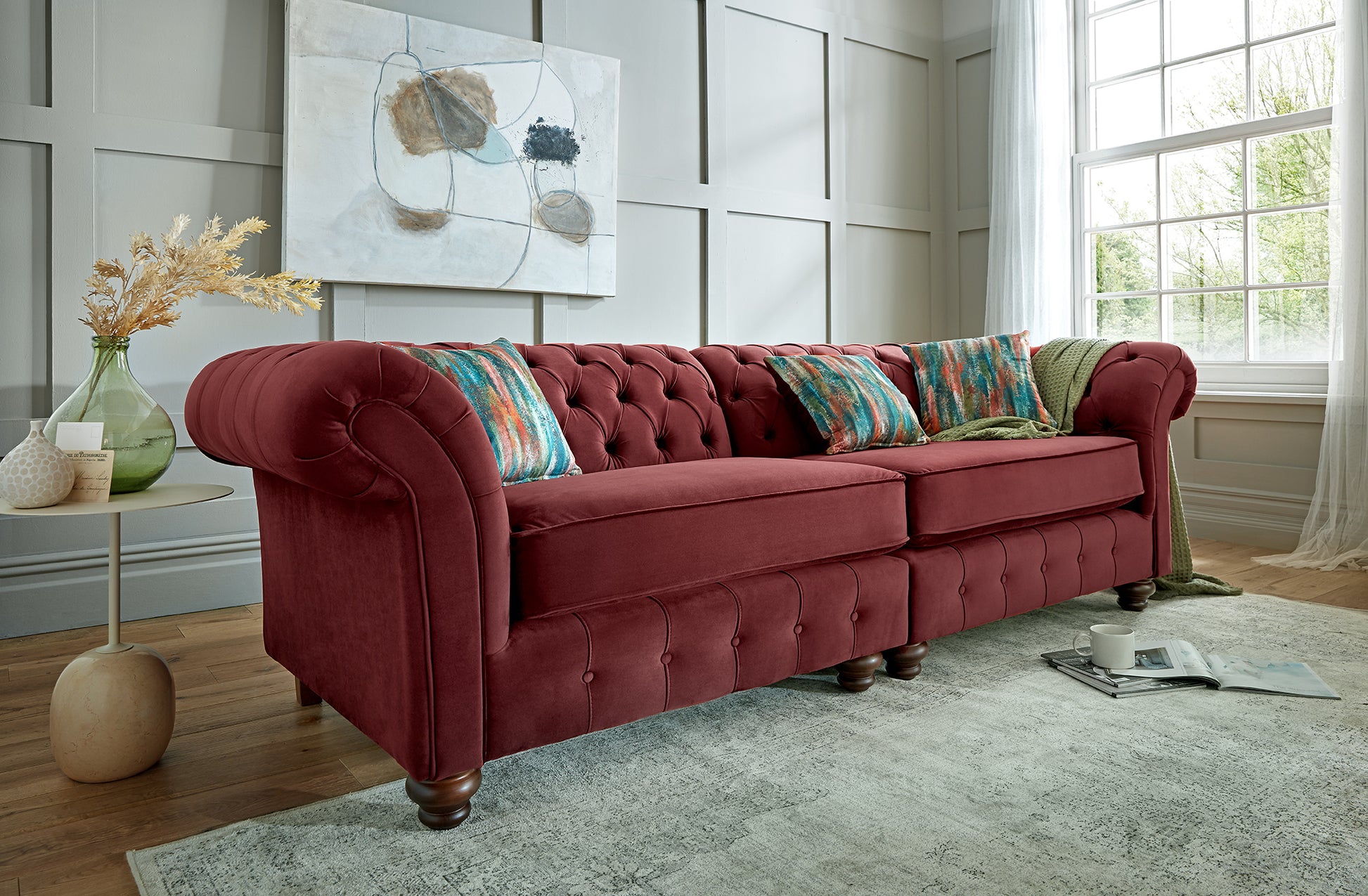 Red sofa with colorful cushions in a living room setting