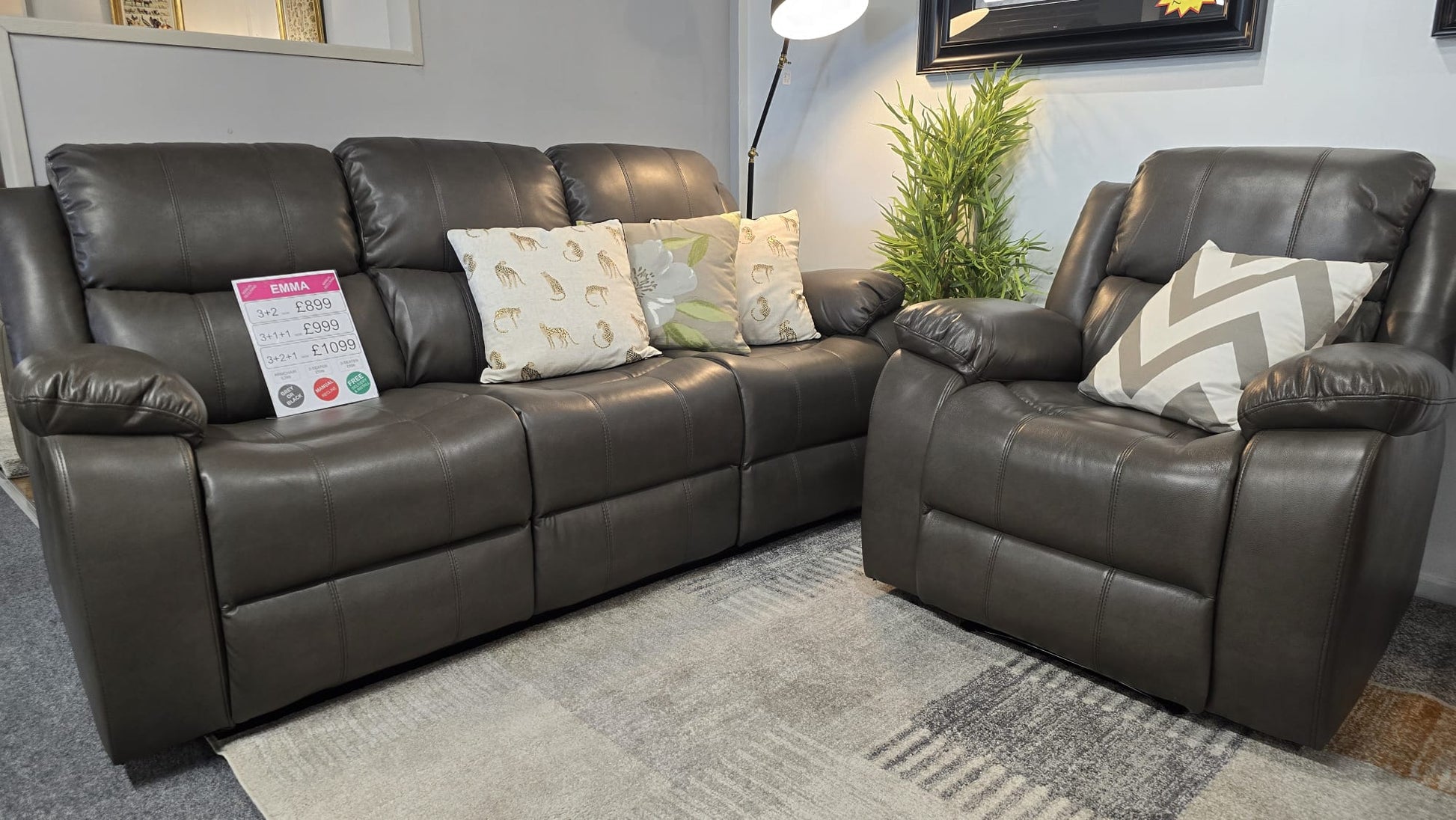 grey leather recliner sofa with cushions in a living room setting
