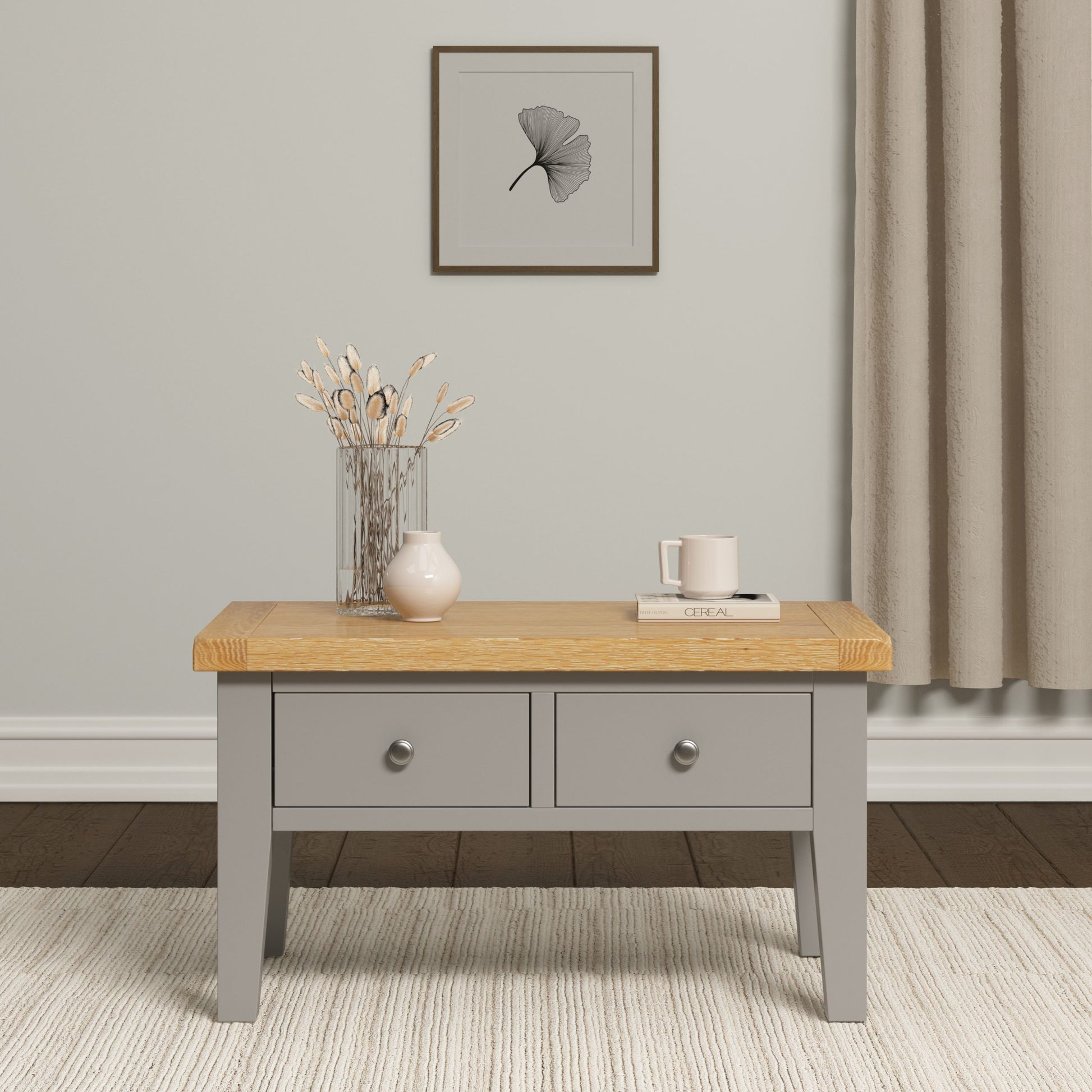 Gray coffee table with wooden top in a room setting with a vase and decor items.