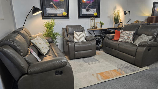 Living room with gray recliner chairs, a coffee table, and decorative items.